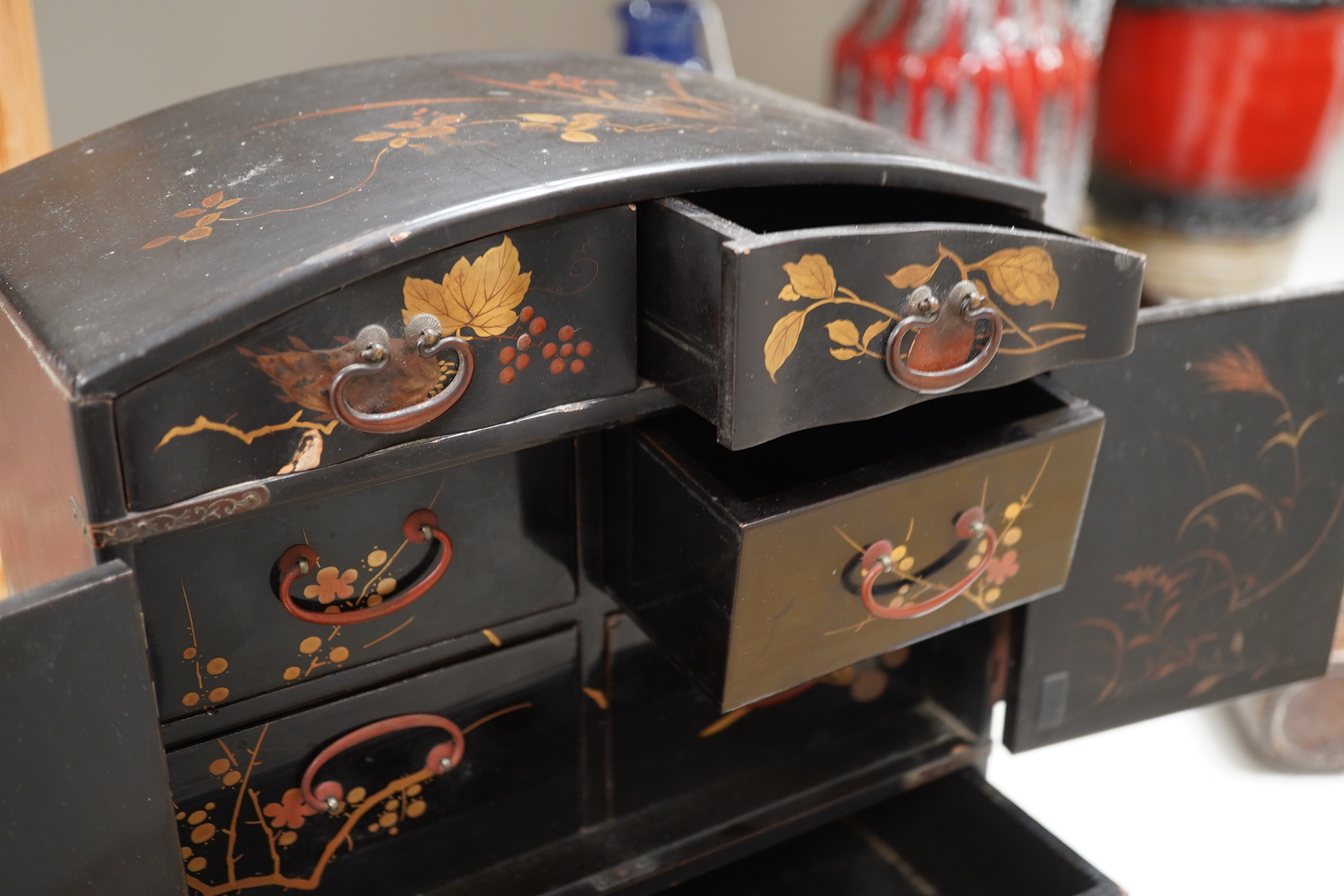 A late 19th early 20th century Japanese lacquer cabinet, 31cm high. Condition - exterior chipped and cracked near the top edge